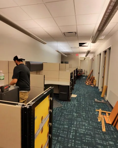 Crew member installing cubicle panels