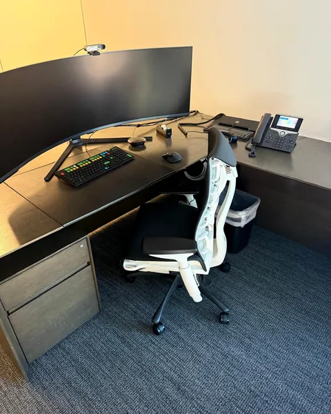 L-shaped executive desk with ergonomic chair