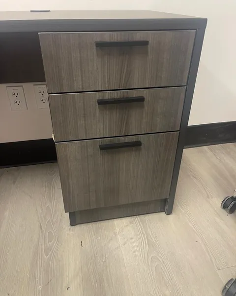Pedestal file cabinet installed under a desk
